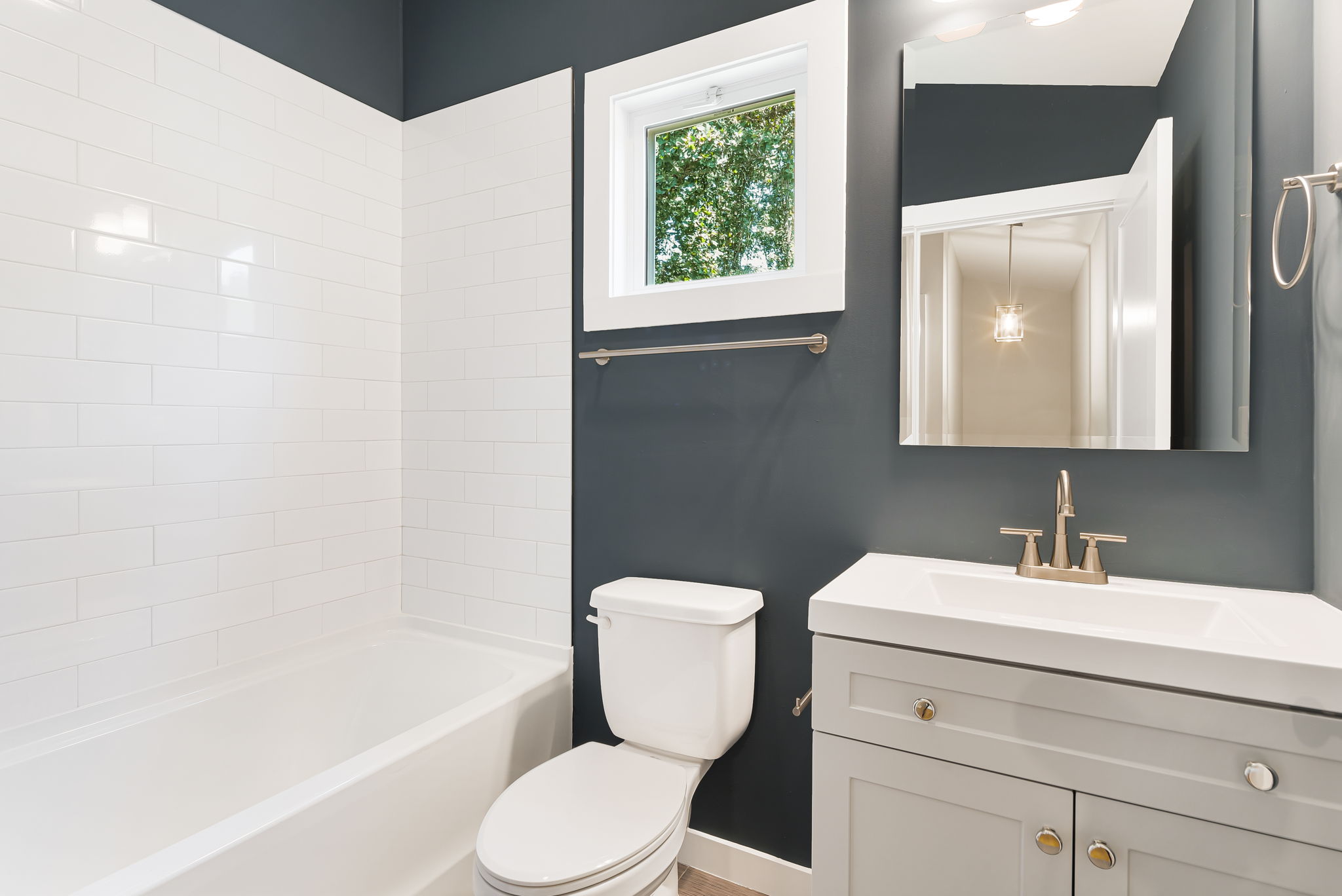 Budget Cottage 2 Bed, bathroom with subway tile and vanity