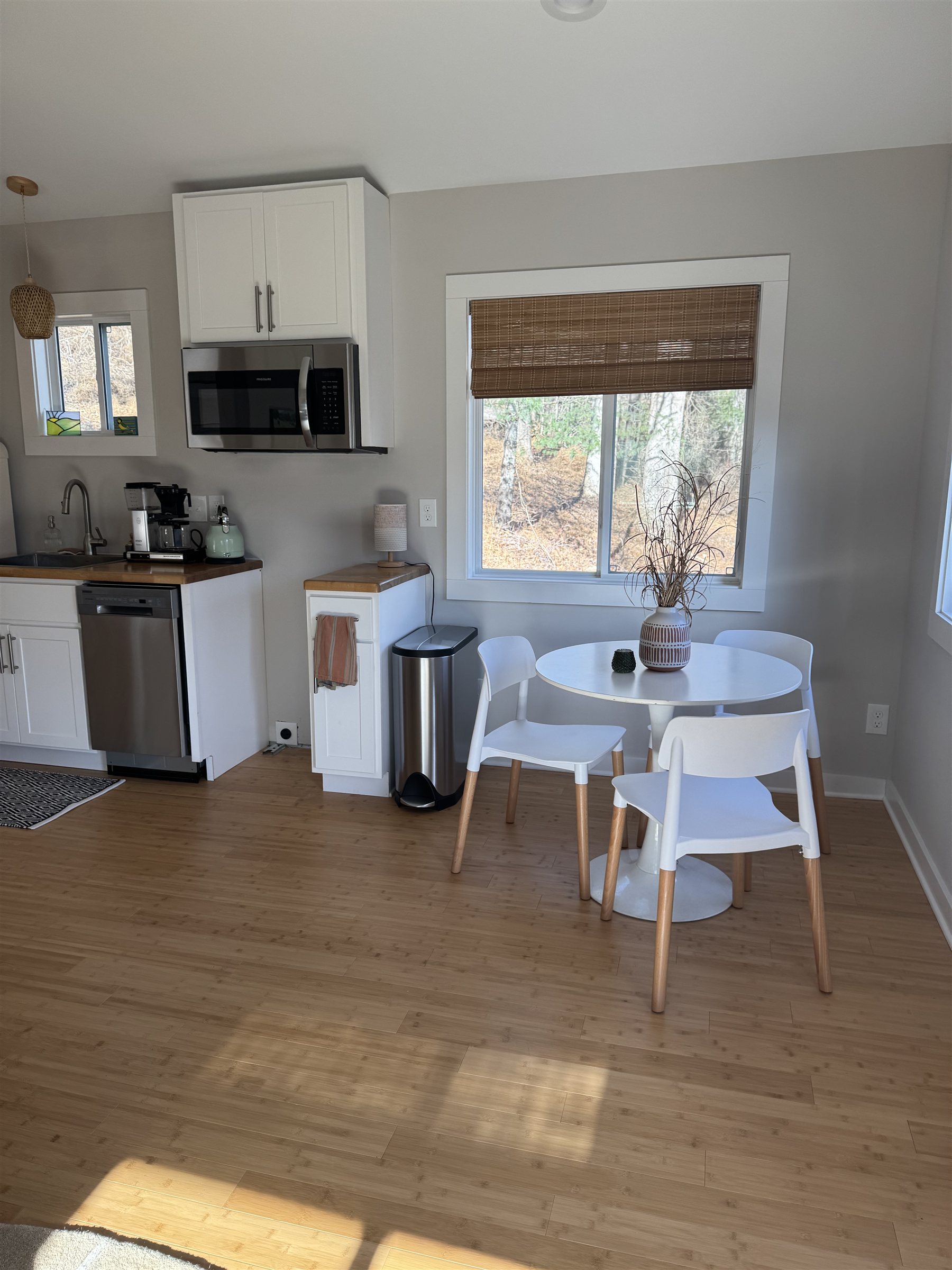 Escape Pod, kitchen with white cabinets and dining nook