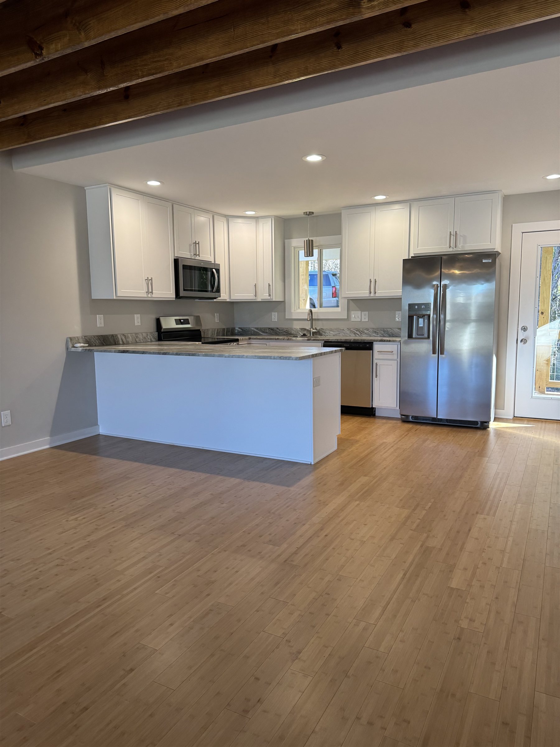 Master on Main 3 Bed, kitchen with white shaker cabinets and stainless appliances