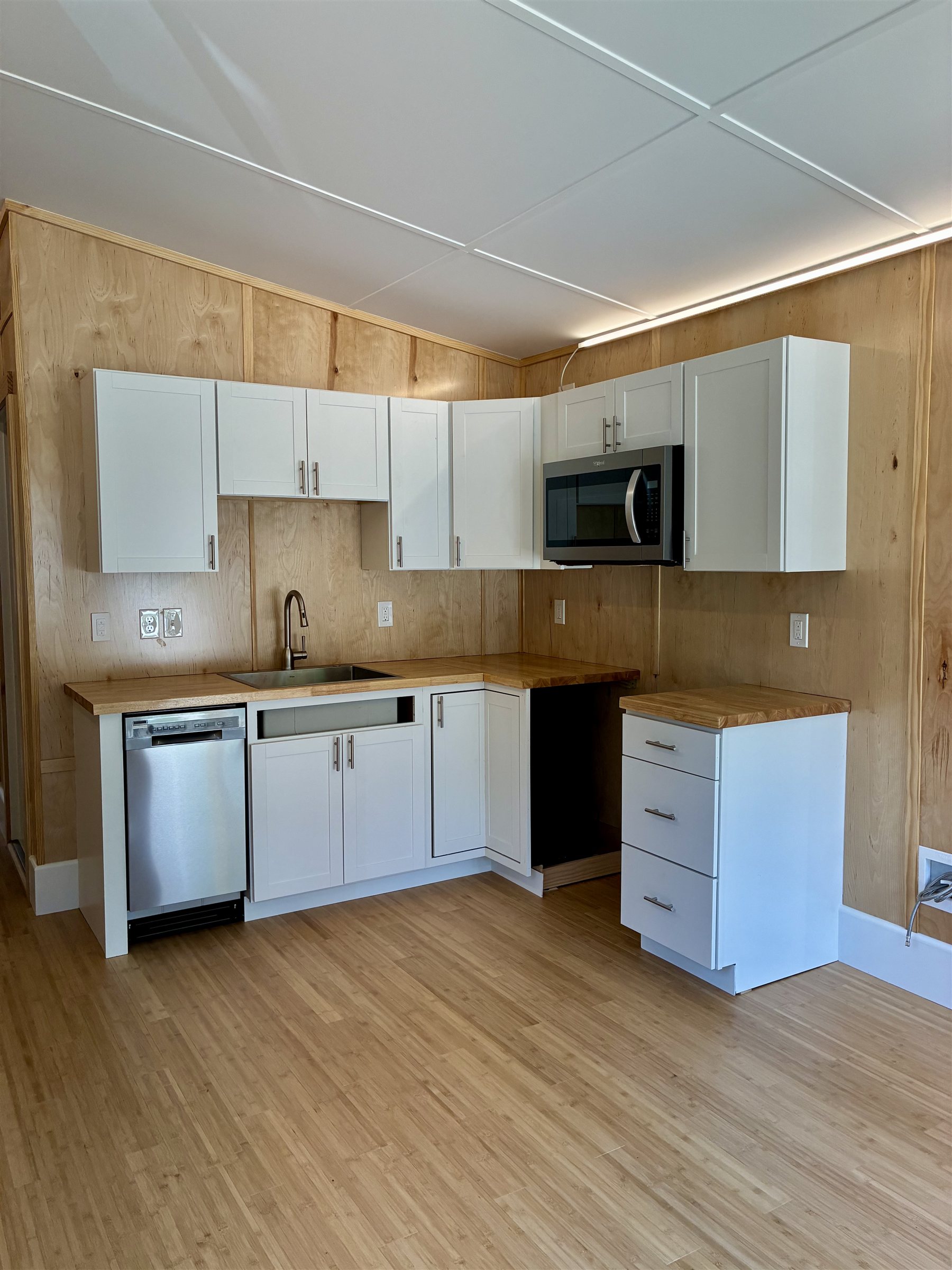 Origami Home kitchen, full L-shaped layout with butcher-block counters
