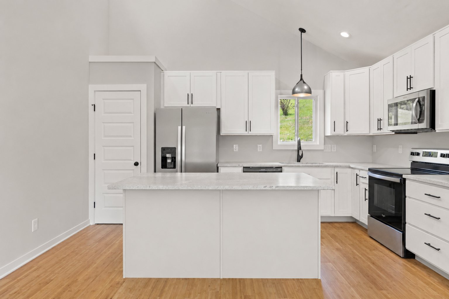 Single Level Cottage 2 Bed, kitchen with white cabinets and stainless appliances