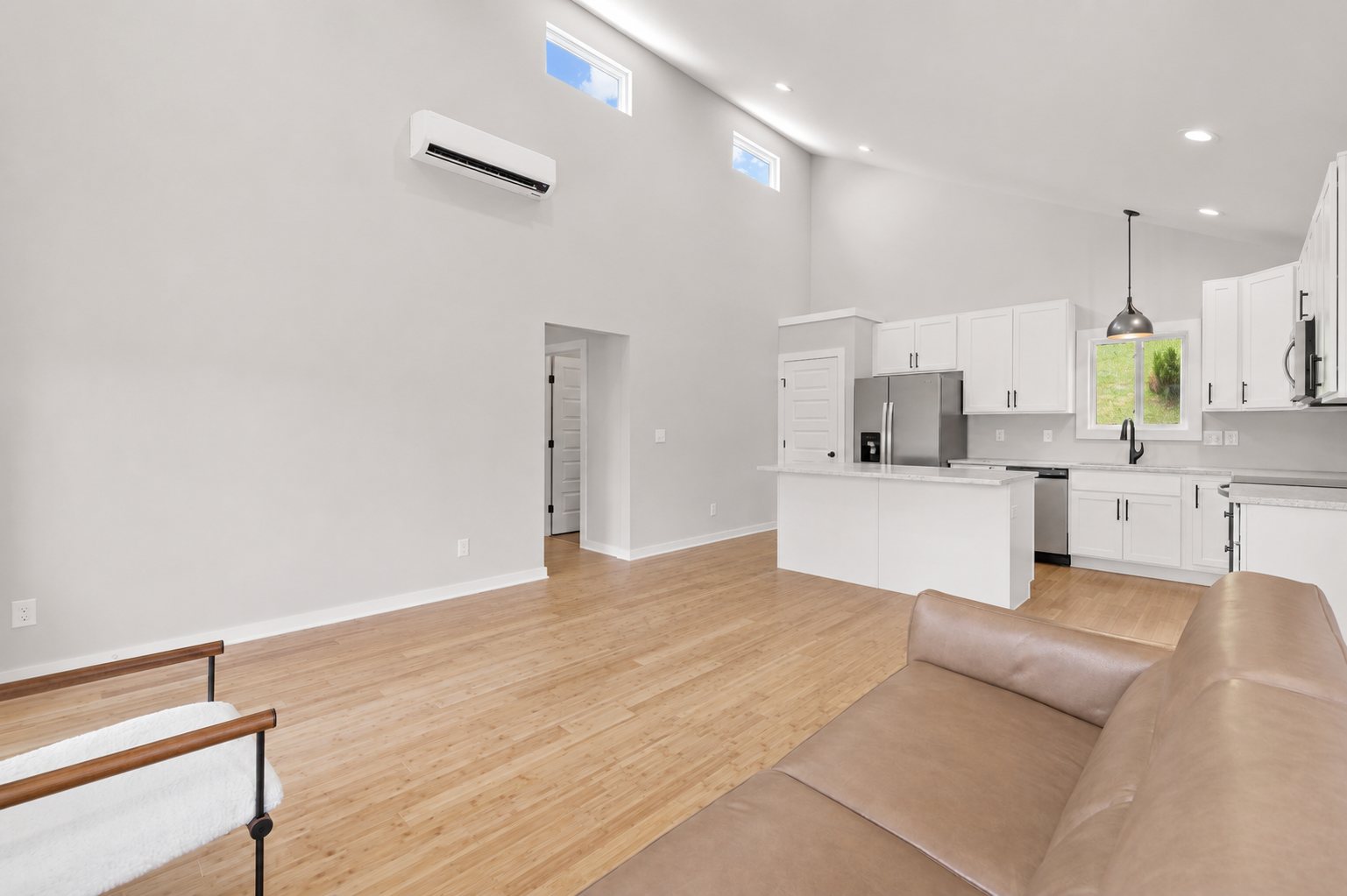 Single Level Cottage 2 Bed, open living room and kitchen with vaulted ceiling